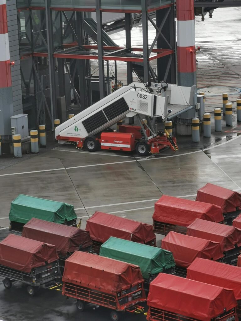 Aerial view of airport baggage trailers and equipment on a rainy day in Hamburg.
