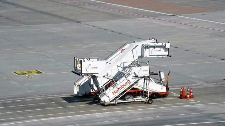 Passenger boarding stairs parked on the tarmac at Hamburg Airport, Germany.