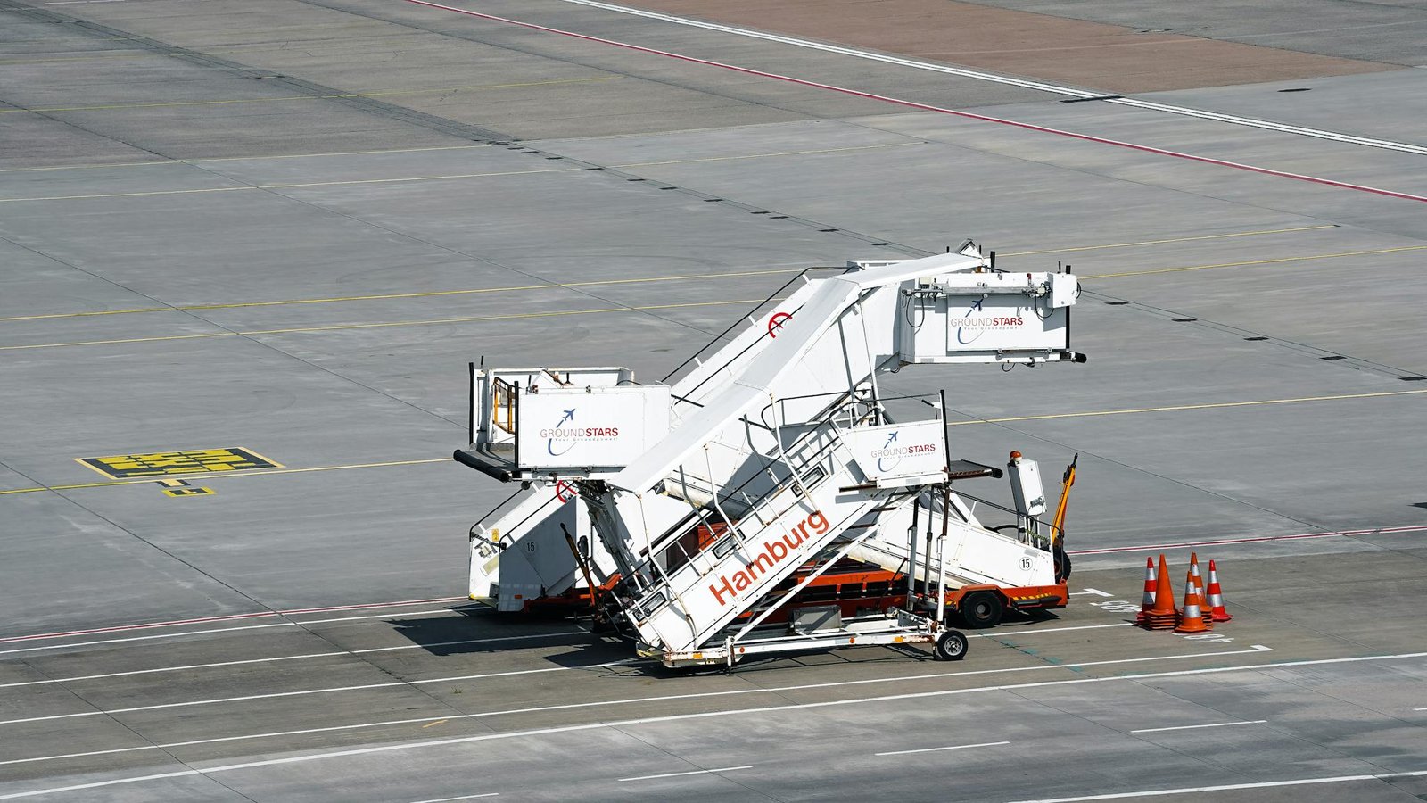 Passenger boarding stairs parked on the tarmac at Hamburg Airport, Germany.